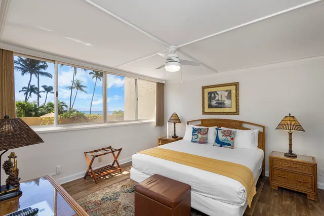 a bedroom with a large bed and a window