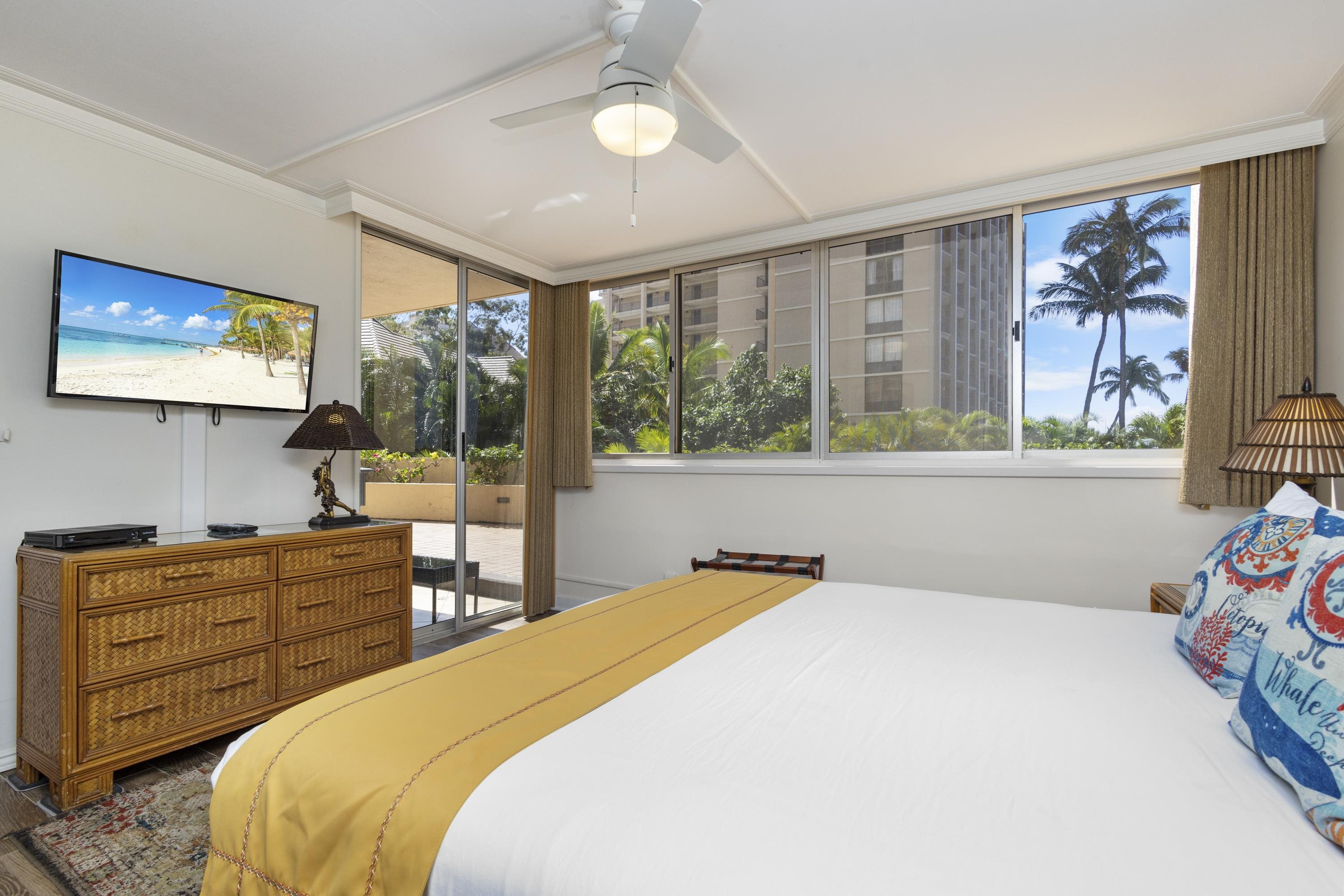 4365 Lower Honoapiilani Road, Unit 115 Lahaina, HI 96761 - Photo 17 of 44 a bedroom with a bed and wooden floor