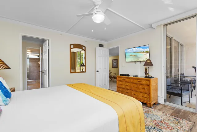 a bedroom with a bed and dresser with mirror