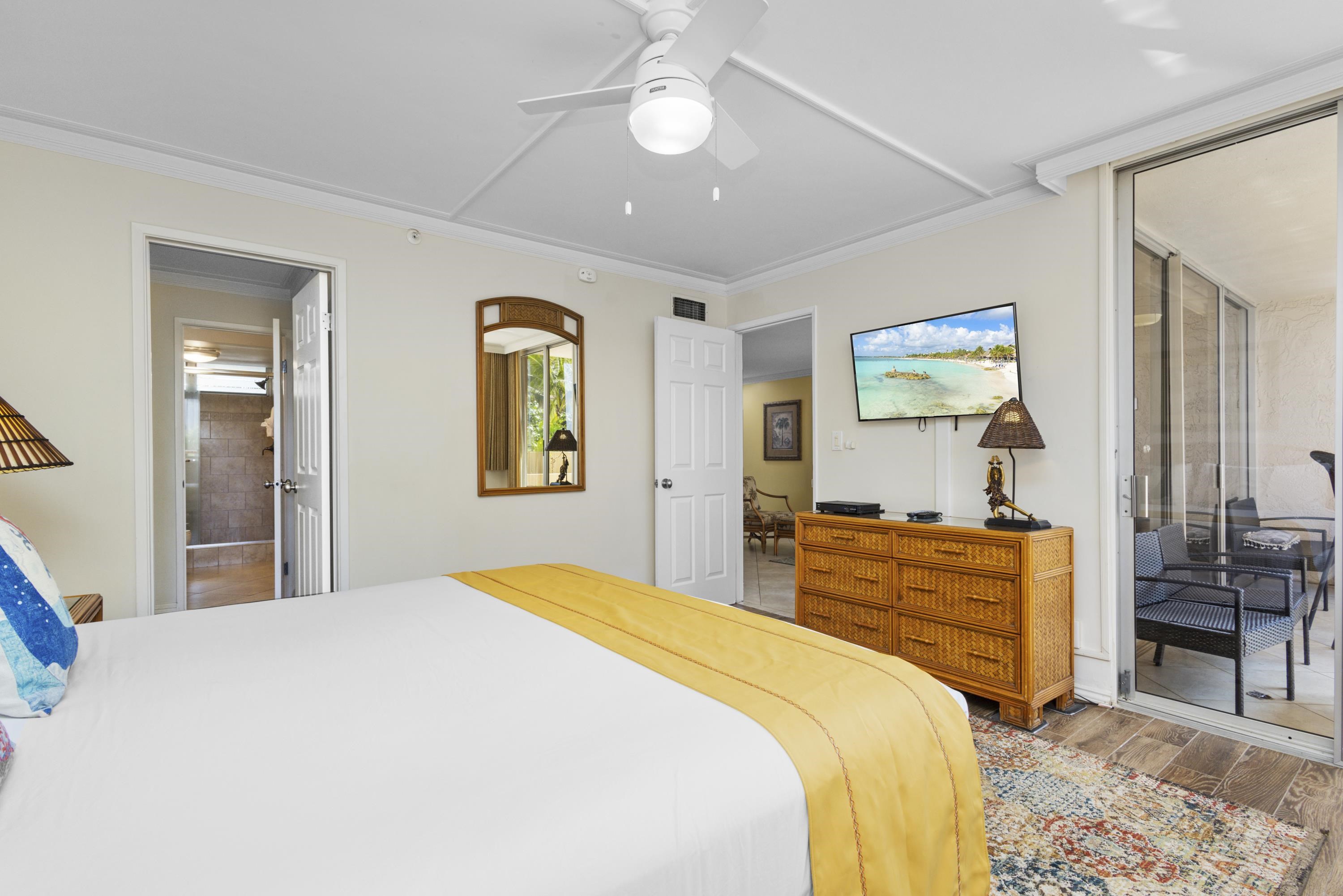 4365 Lower Honoapiilani Road, Unit 115 Lahaina, HI 96761 - Photo 19 of 44 a bedroom with a bed and dresser with mirror