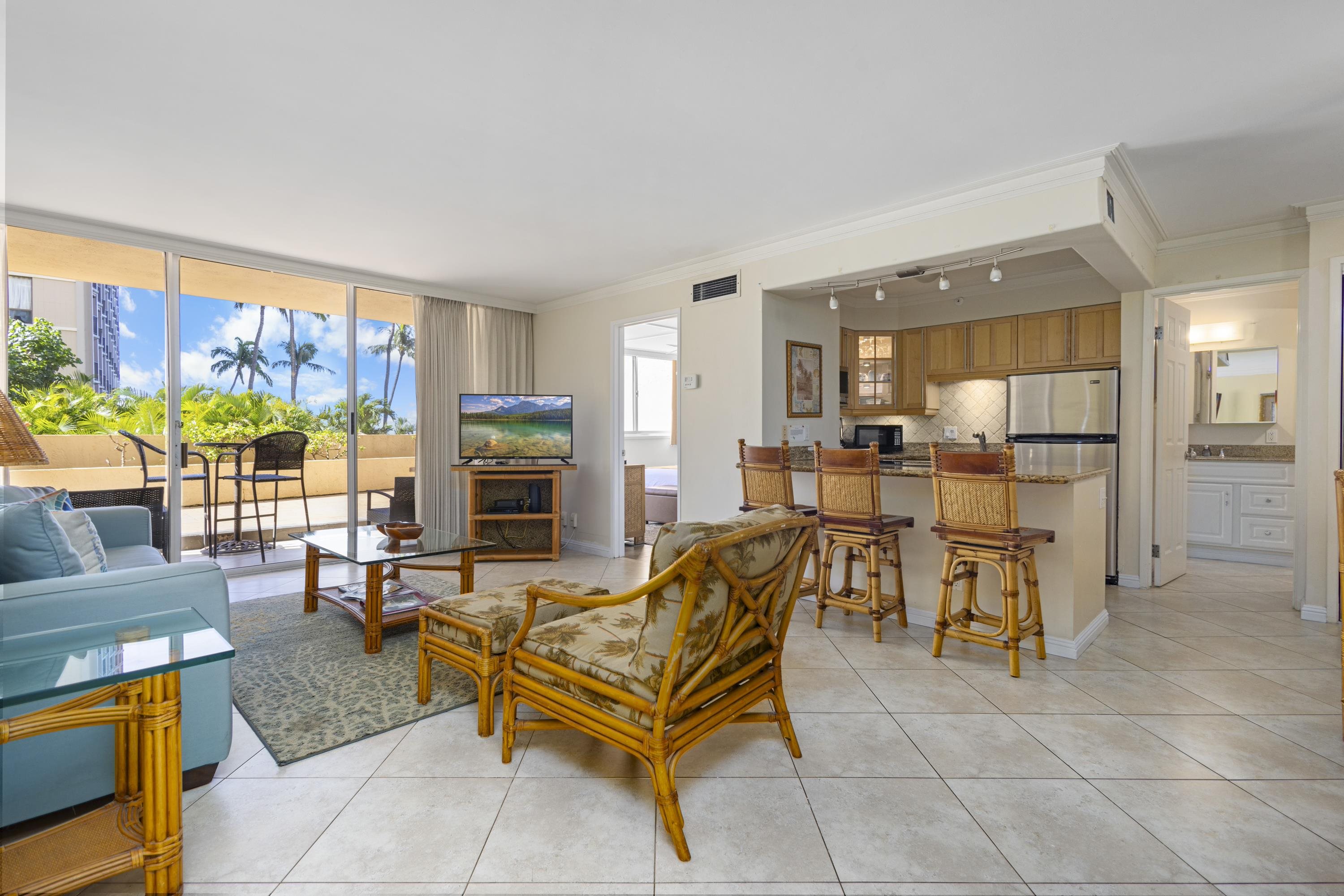 4365 Lower Honoapiilani Road, Unit 115 Lahaina, HI 96761 - Photo 2 of 44 a living room with furniture and a fireplace