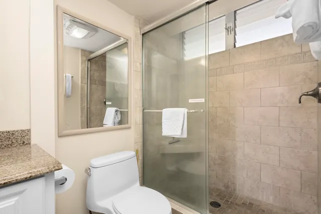 a white toilet sitting next to a bathroom sink
