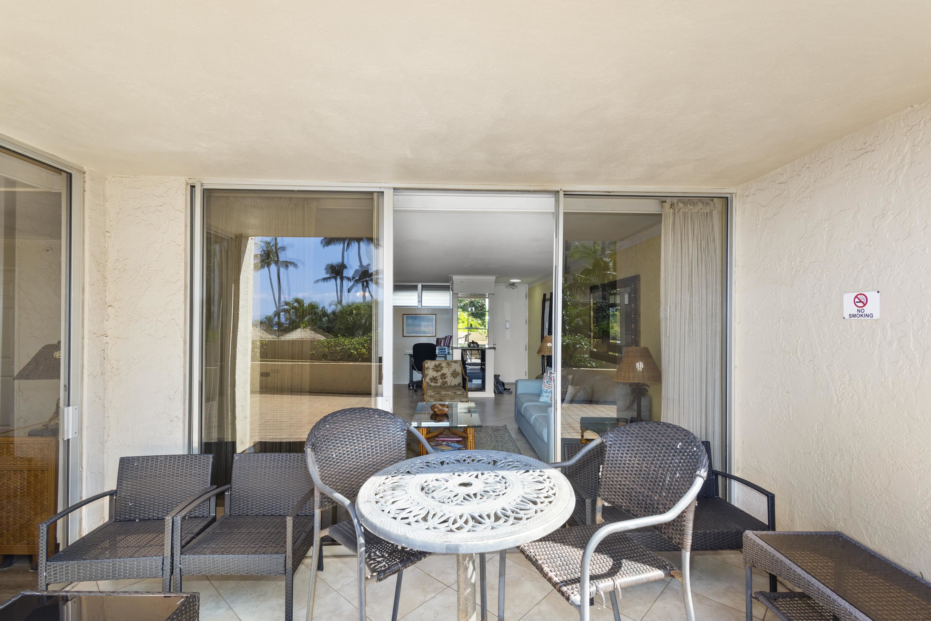 4365 Lower Honoapiilani Road, Unit 115 Lahaina, HI 96761 - Photo 28 of 44 a dining room with furniture and wooden floor