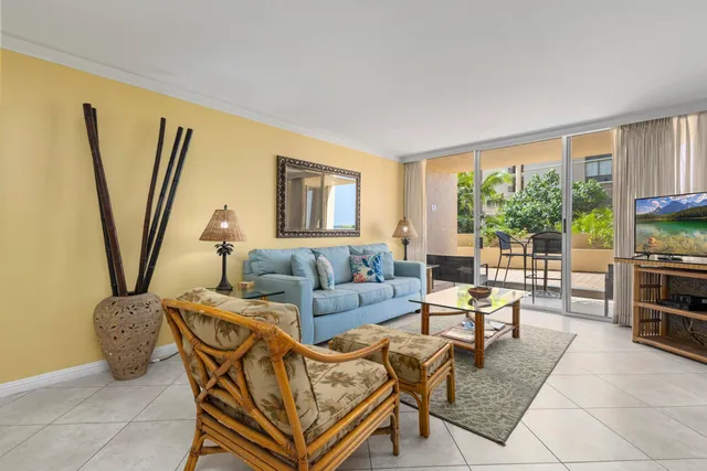 a living room with furniture a large window and a flat screen tv