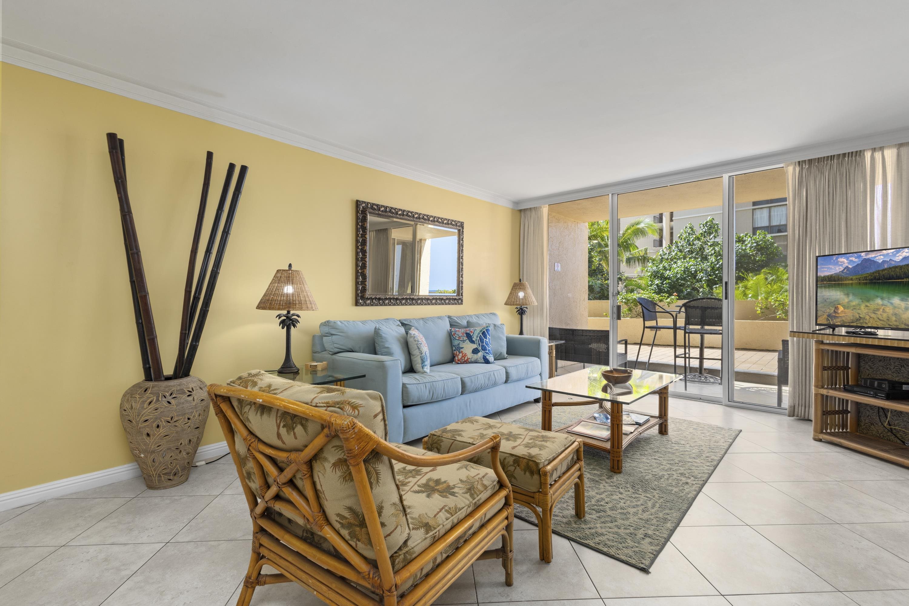 4365 Lower Honoapiilani Road, Unit 115 Lahaina, HI 96761 - Photo 3 of 44 a living room with furniture a large window and a flat screen tv