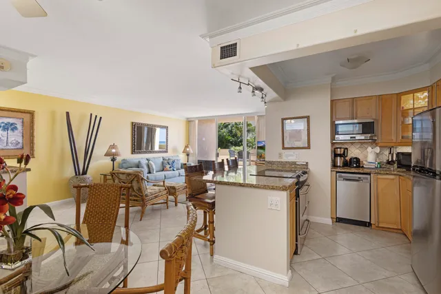 a very nice looking open dining room with kitchen island