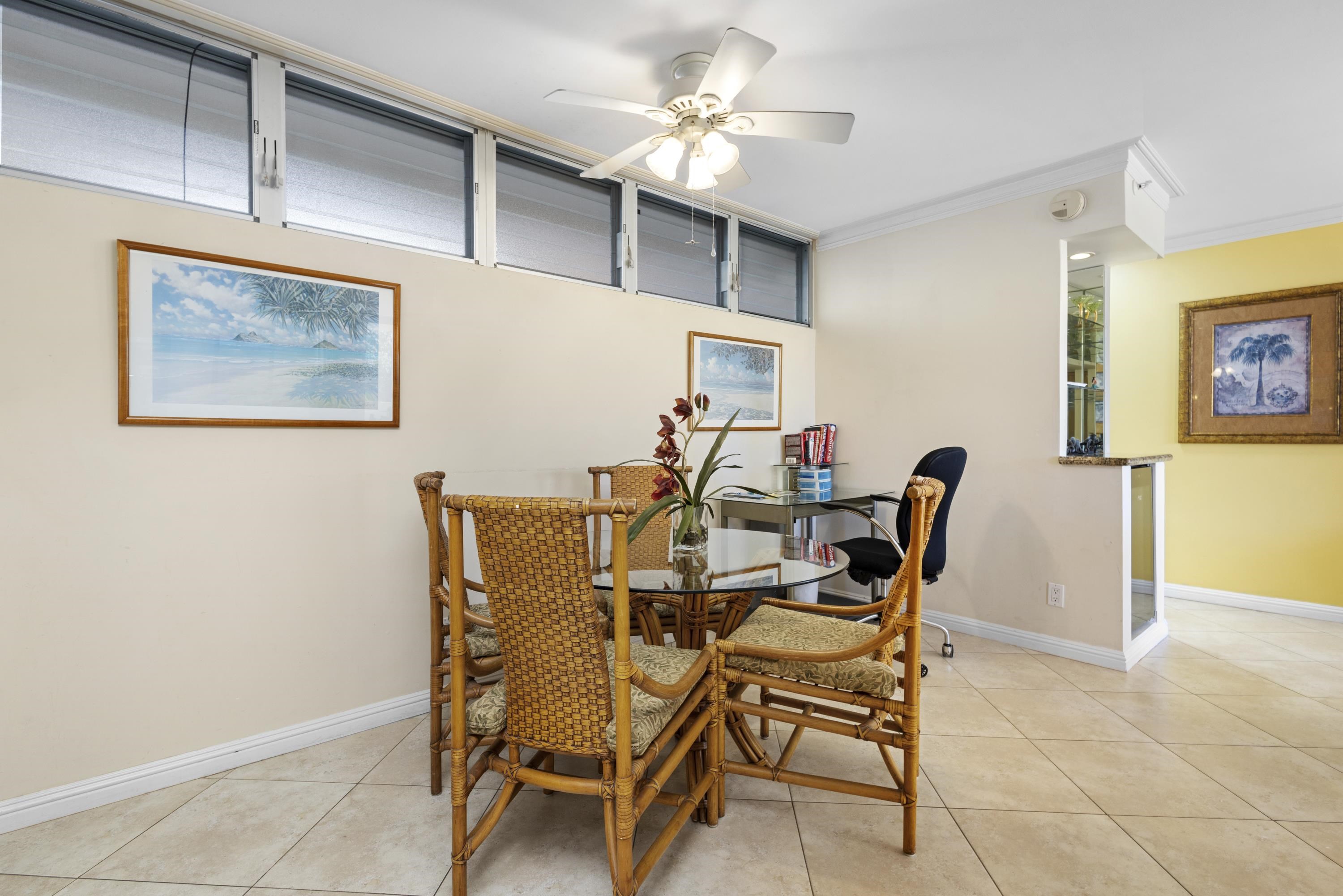 4365 Lower Honoapiilani Road, Unit 115 Lahaina, HI 96761 - Photo 8 of 44 a dining room with furniture and a chandelier