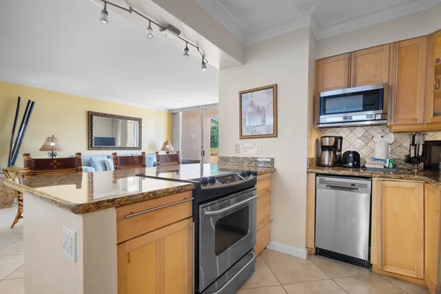 a kitchen with stainless steel appliances granite countertop a sink stove oven and microwave