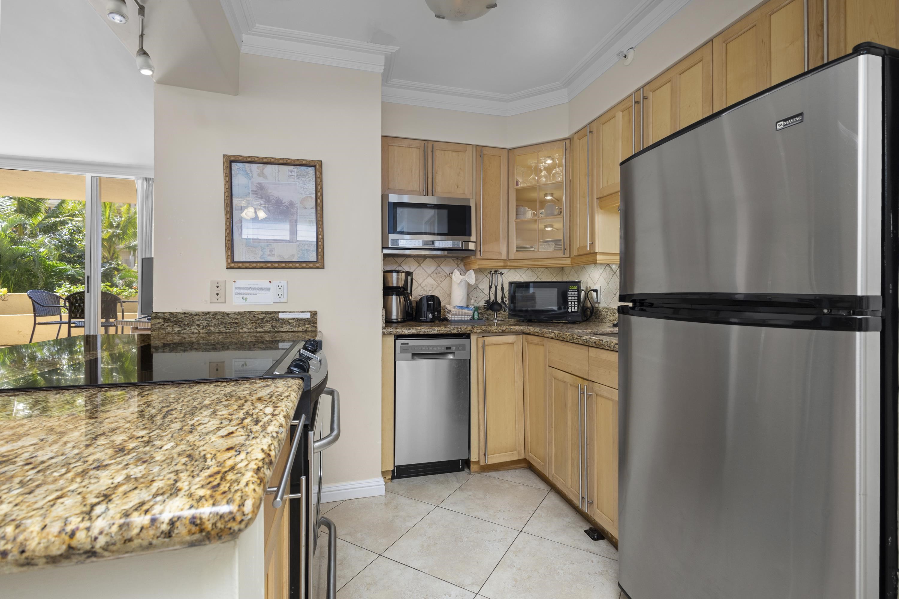 4365 Lower Honoapiilani Road, Unit 115 Lahaina, HI 96761 - Photo 10 of 44 a kitchen with a refrigerator and a stove top oven