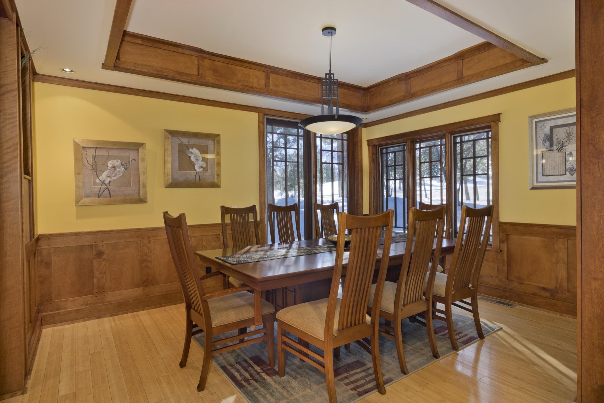 56 Wagon Road Mammoth Lakes, CA 93546 - Photo 14 of 56 Dining area featuring a tray ceiling, wainscoting, light wood-type flooring, ornamental molding, and wood walls