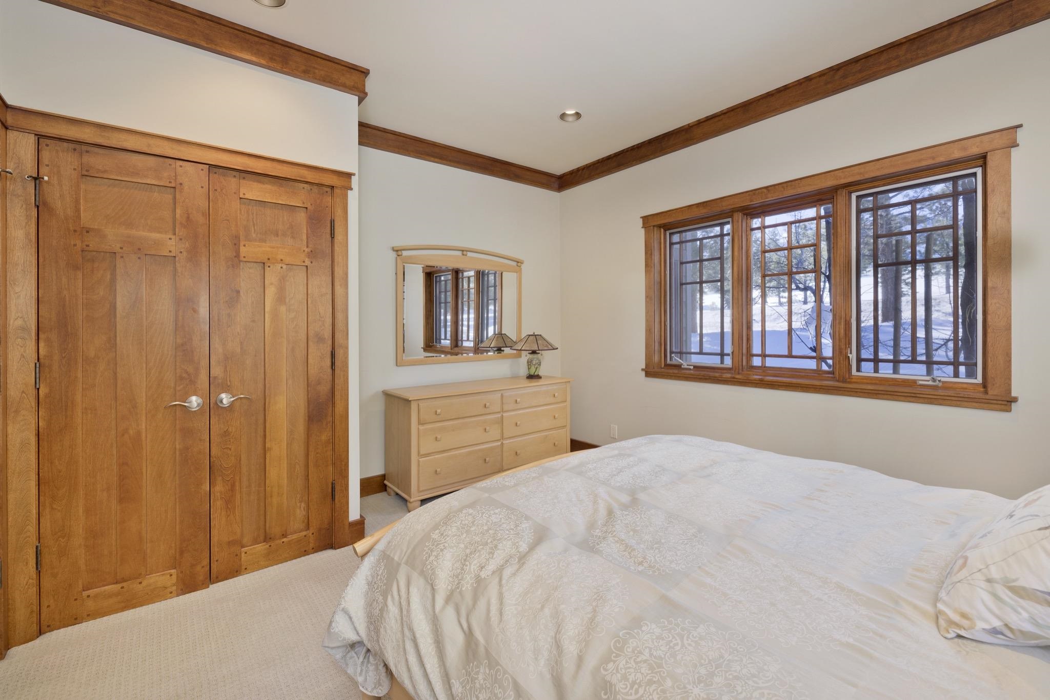 56 Wagon Road Mammoth Lakes, CA 93546 - Photo 18 of 56 Bedroom with a closet, light carpet, and ornamental molding