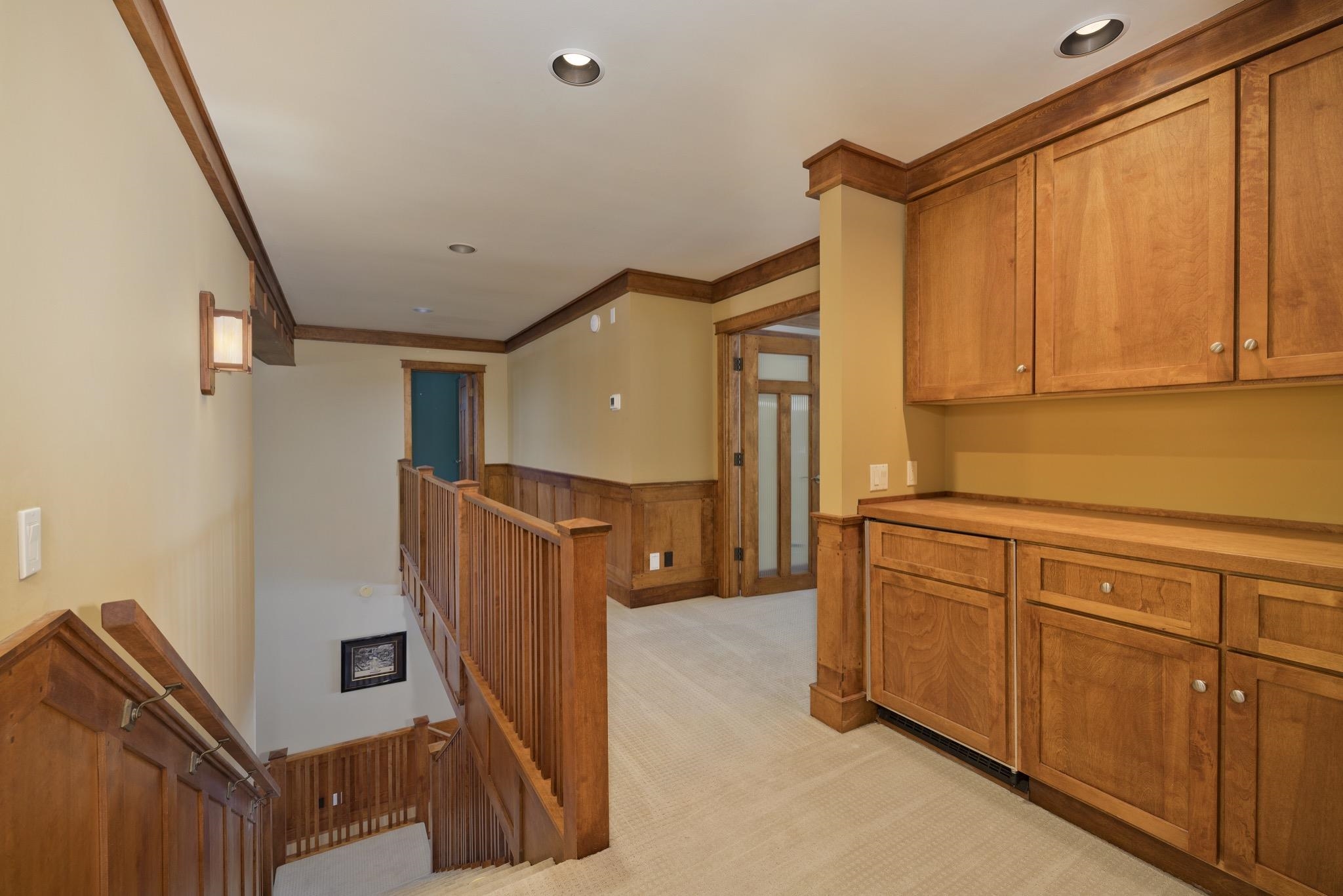 56 Wagon Road Mammoth Lakes, CA 93546 - Photo 21 of 56 Hallway with an upstairs landing, ornamental molding, recessed lighting, light carpet, and a wainscoted wall