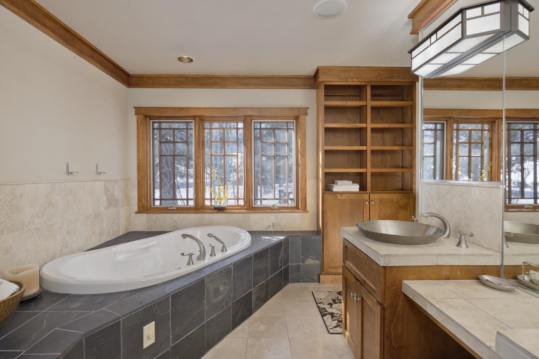 56 Wagon Road Mammoth Lakes, CA 93546 - Photo 27 of 48 a bathroom with a granite countertop sink and a bathtub
