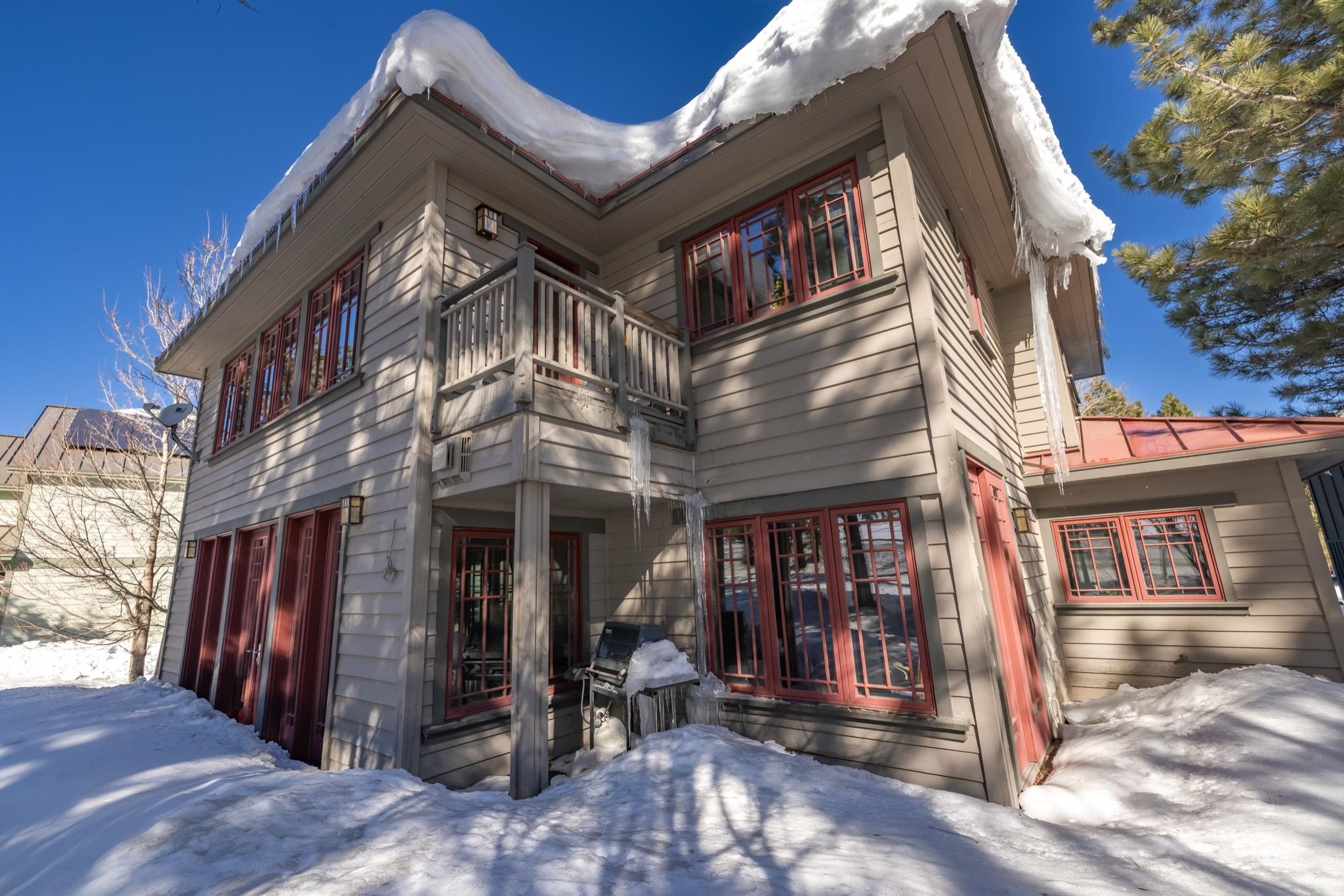 56 Wagon Road Mammoth Lakes, CA 93546 - Photo 3 of 56 Snow covered rear of property featuring a balcony and a metal roof