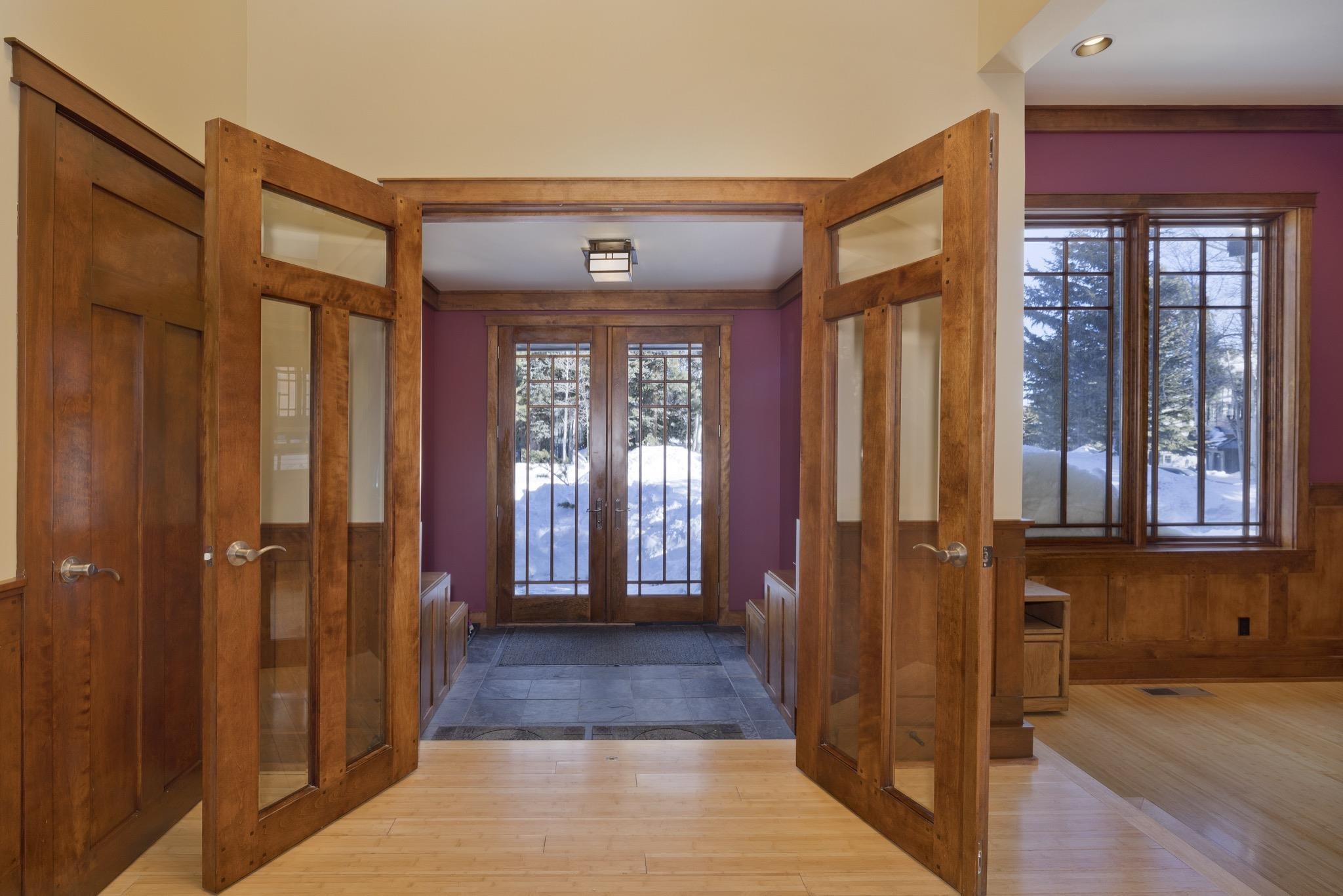 56 Wagon Road Mammoth Lakes, CA 93546 - Photo 4 of 56 Foyer with french doors, a wainscoted wall, wood finished floors, and wooden walls