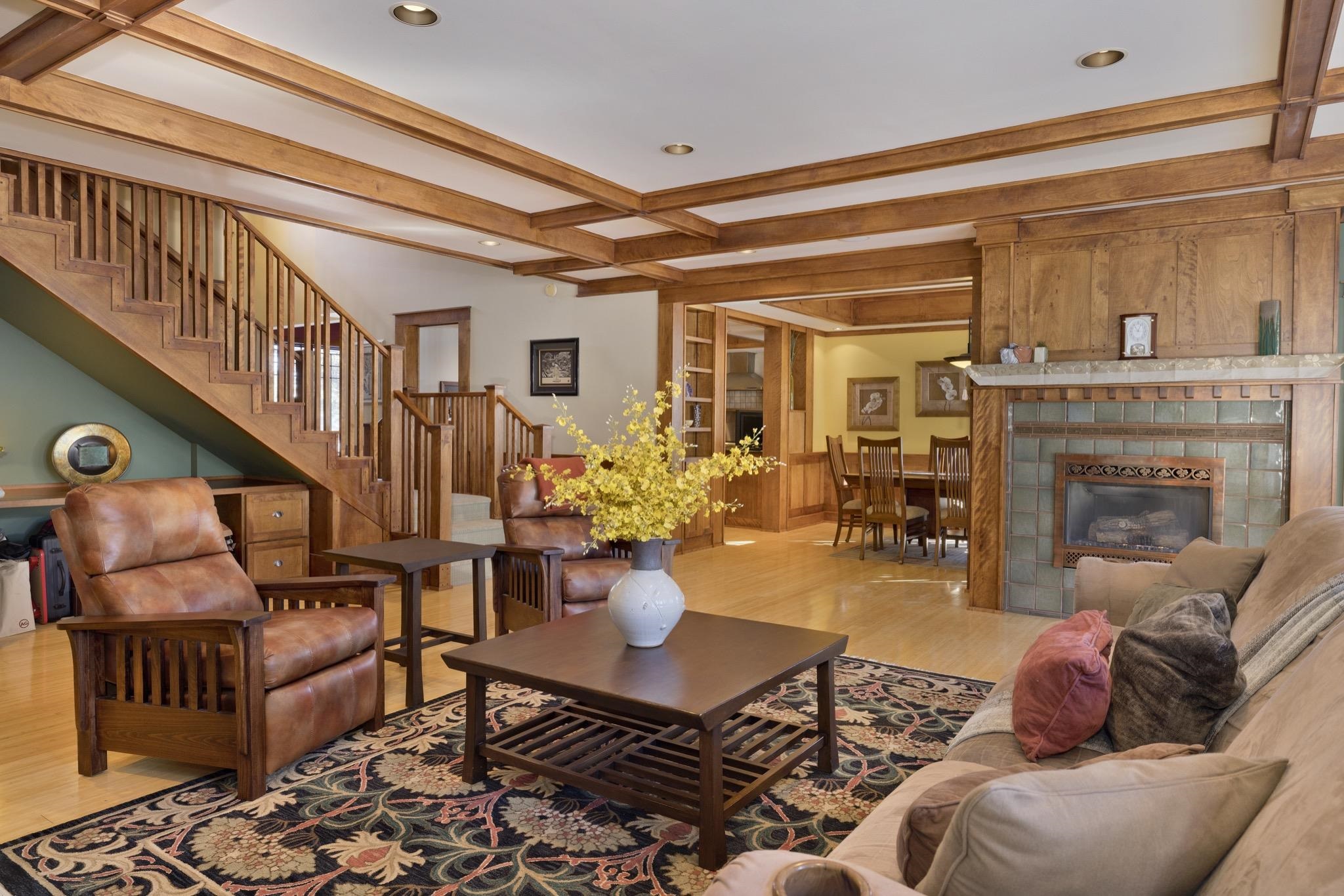 56 Wagon Road Mammoth Lakes, CA 93546 - Photo 45 of 56 Living area featuring beamed ceiling, light wood-style floors, a tiled fireplace, stairs, and recessed lighting