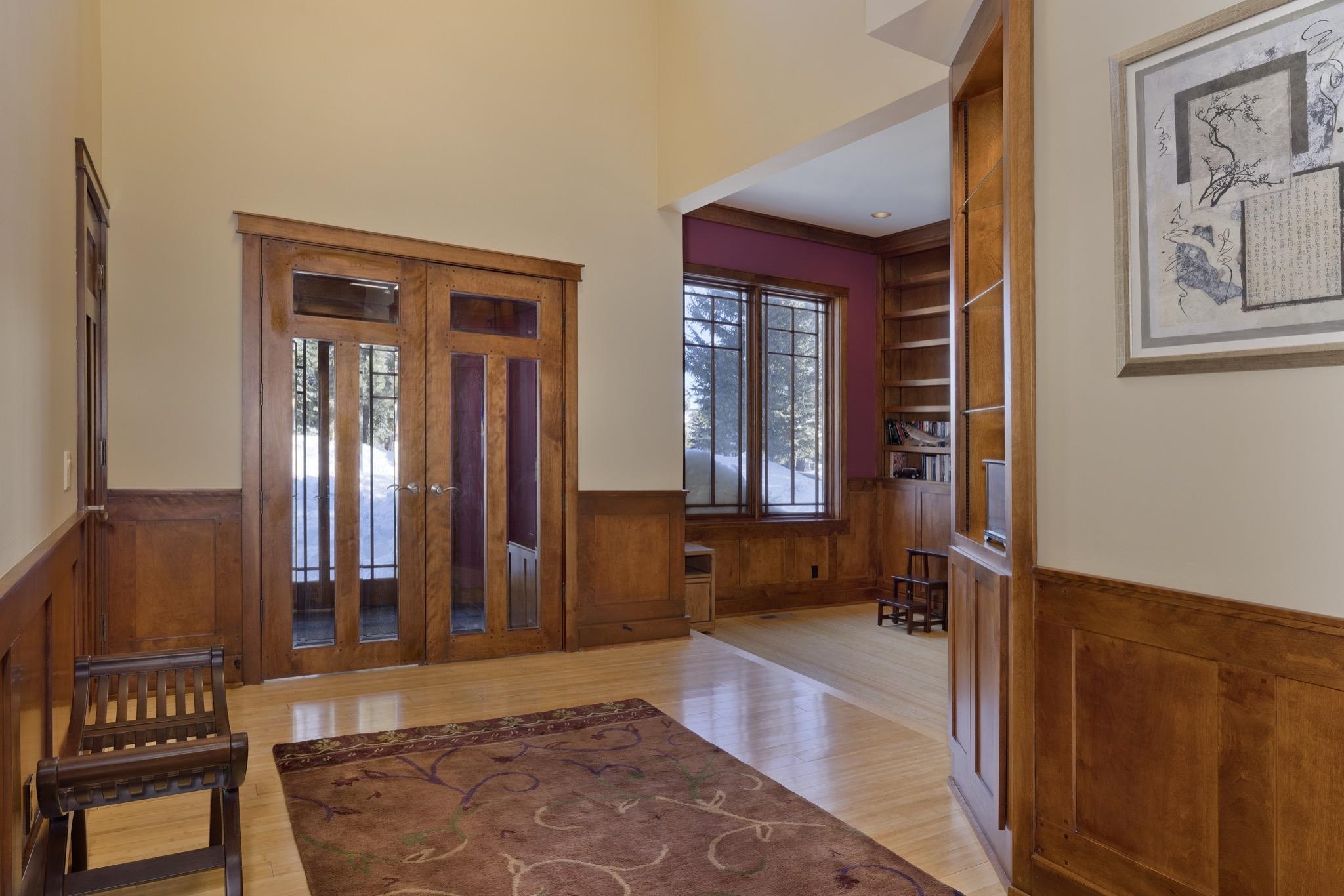 56 Wagon Road Mammoth Lakes, CA 93546 - Photo 5 of 56 Entrance foyer with a wainscoted wall, light wood-type flooring, a decorative wall, and wood walls
