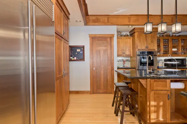 a kitchen with refrigerator and table
