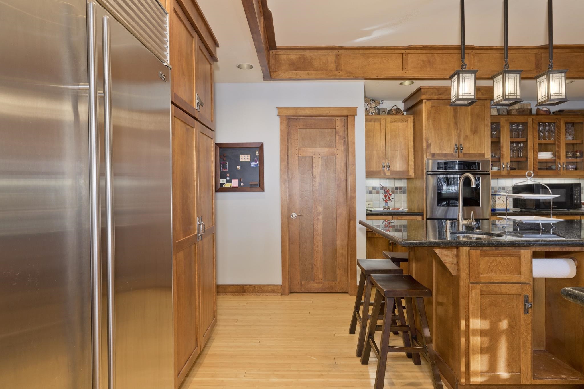 56 Wagon Road Mammoth Lakes, CA 93546 - Photo 6 of 48 a kitchen with refrigerator and table
