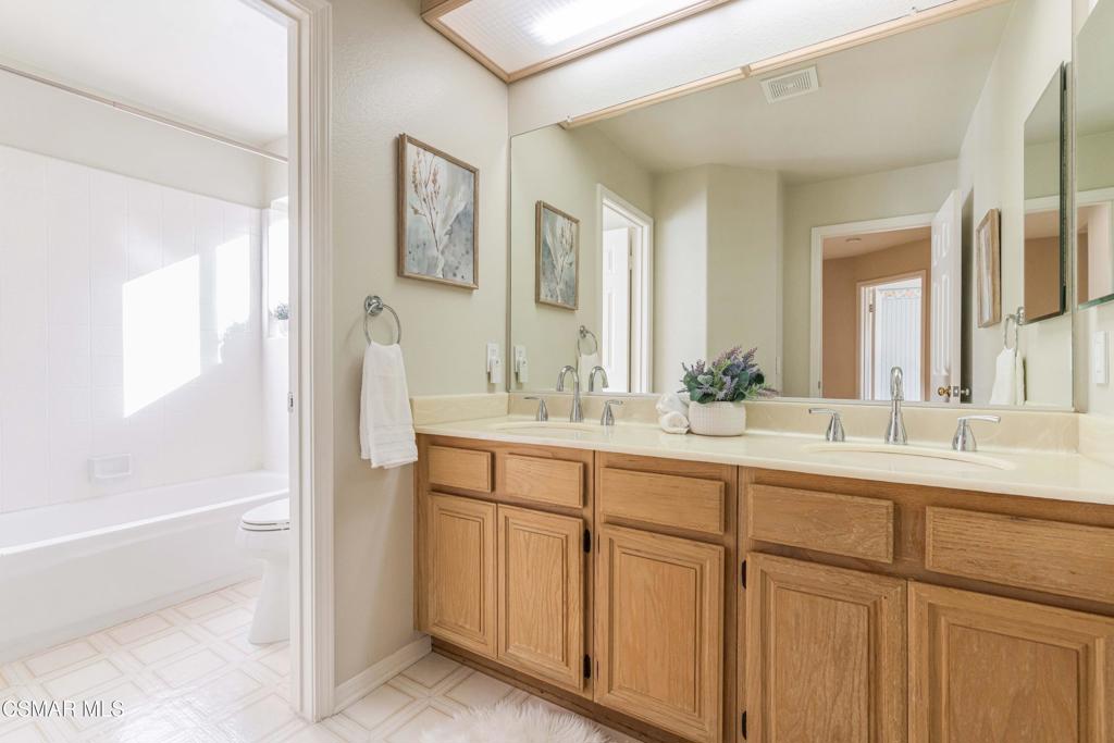 368 Pellburne Court Simi Valley, CA 93065 - Photo 35 of 55 a bathroom with a double vanity sink a mirror and a bathtub