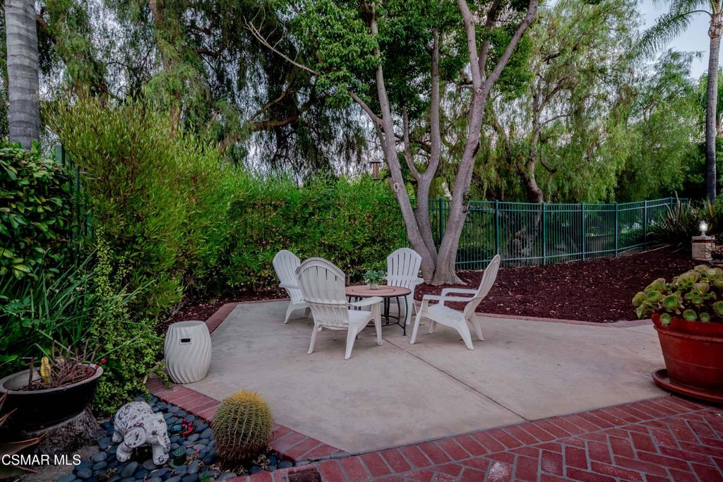 368 Pellburne Court Simi Valley, CA 93065 - Photo 43 of 55 a view of a patio with table and chairs potted plants and large tree