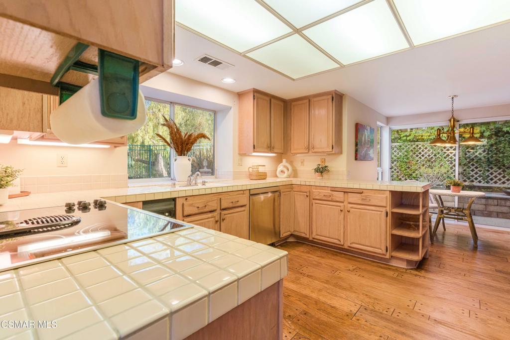 368 Pellburne Court Simi Valley, CA 93065 - Photo 10 of 55 a kitchen with a sink a window and cabinets