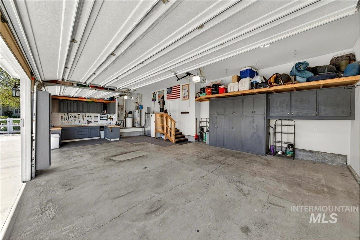 414 East Shafer View Drive Meridian, ID 83642 - Photo 36 of 50 Spacious 38" Wide x 22" Deep oversized 3 car garage with concrete flooring, built-in cabinetry, integrated workbench w/hot & cold utility sink, fully finished & painted walls, Gas Furnace & water heater, Cent. Vac, Water Softener, Well Pressure equip.