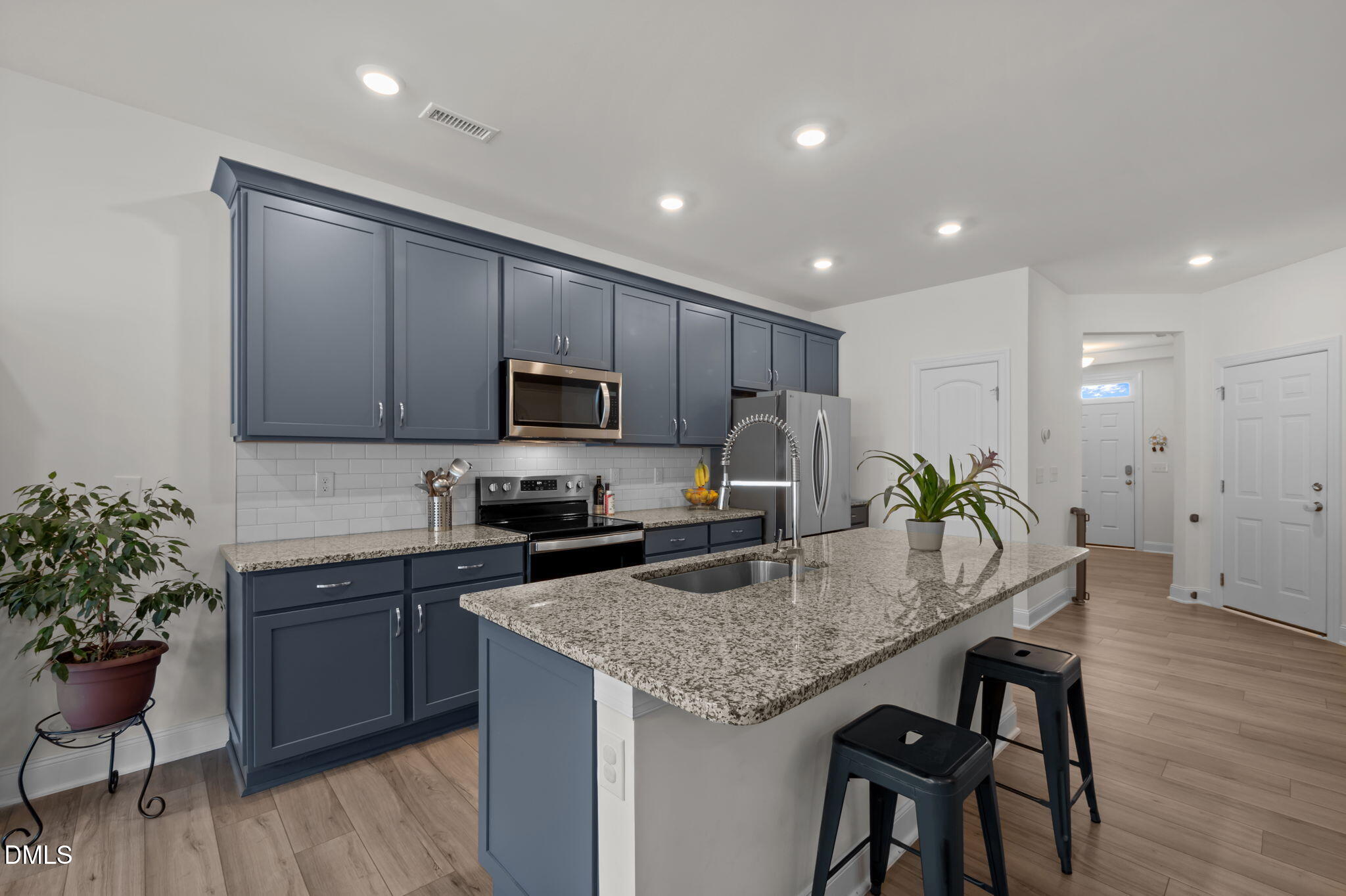 1031 Culloden Circle Durham, NC 27713 - Photo 11 of 50 a kitchen with granite countertop kitchen island stainless steel appliances a sink and stove