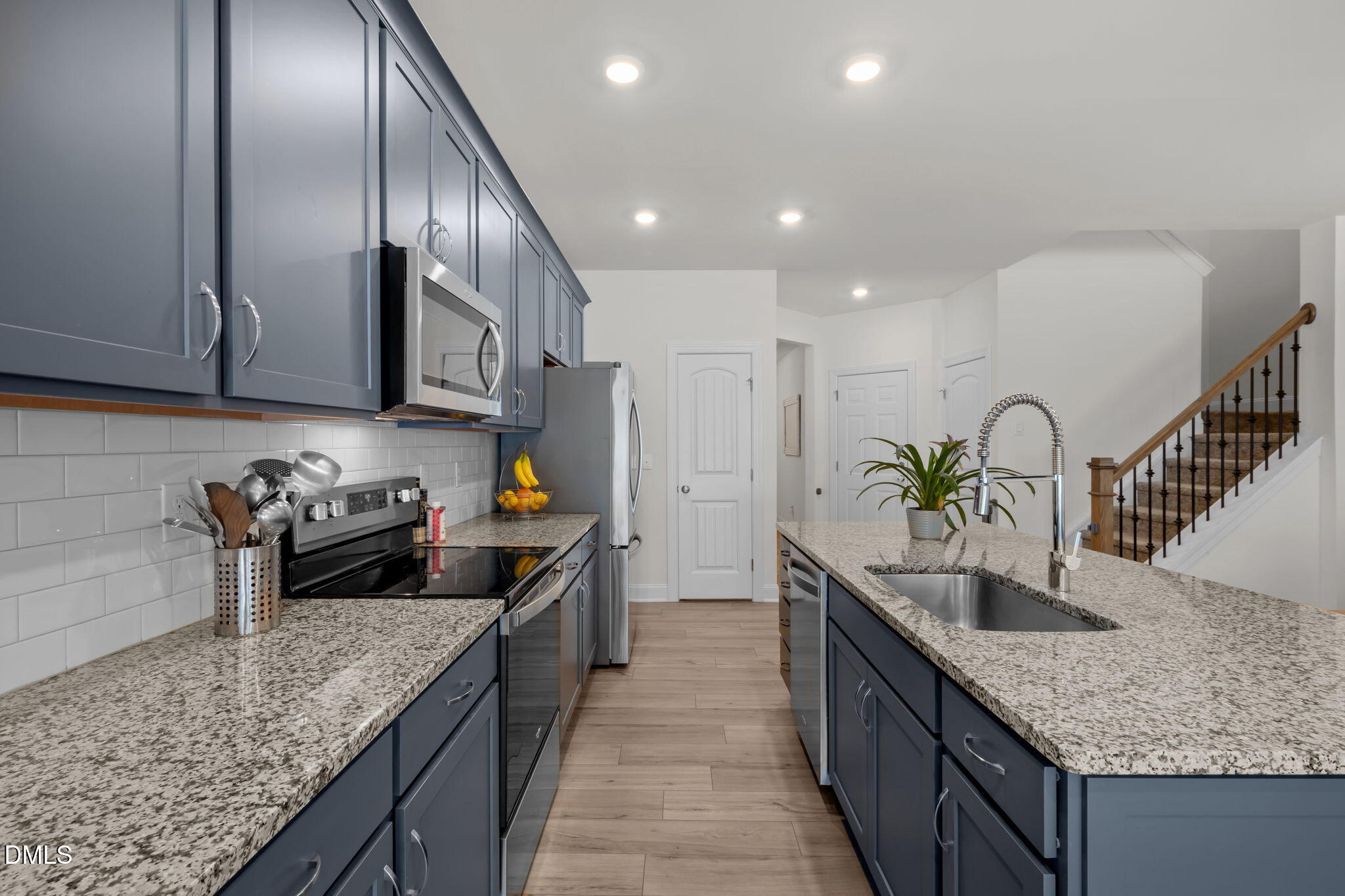 1031 Culloden Circle Durham, NC 27713 - Photo 12 of 50 a kitchen with granite countertop stainless steel appliances a sink a counter top space cabinets and stove