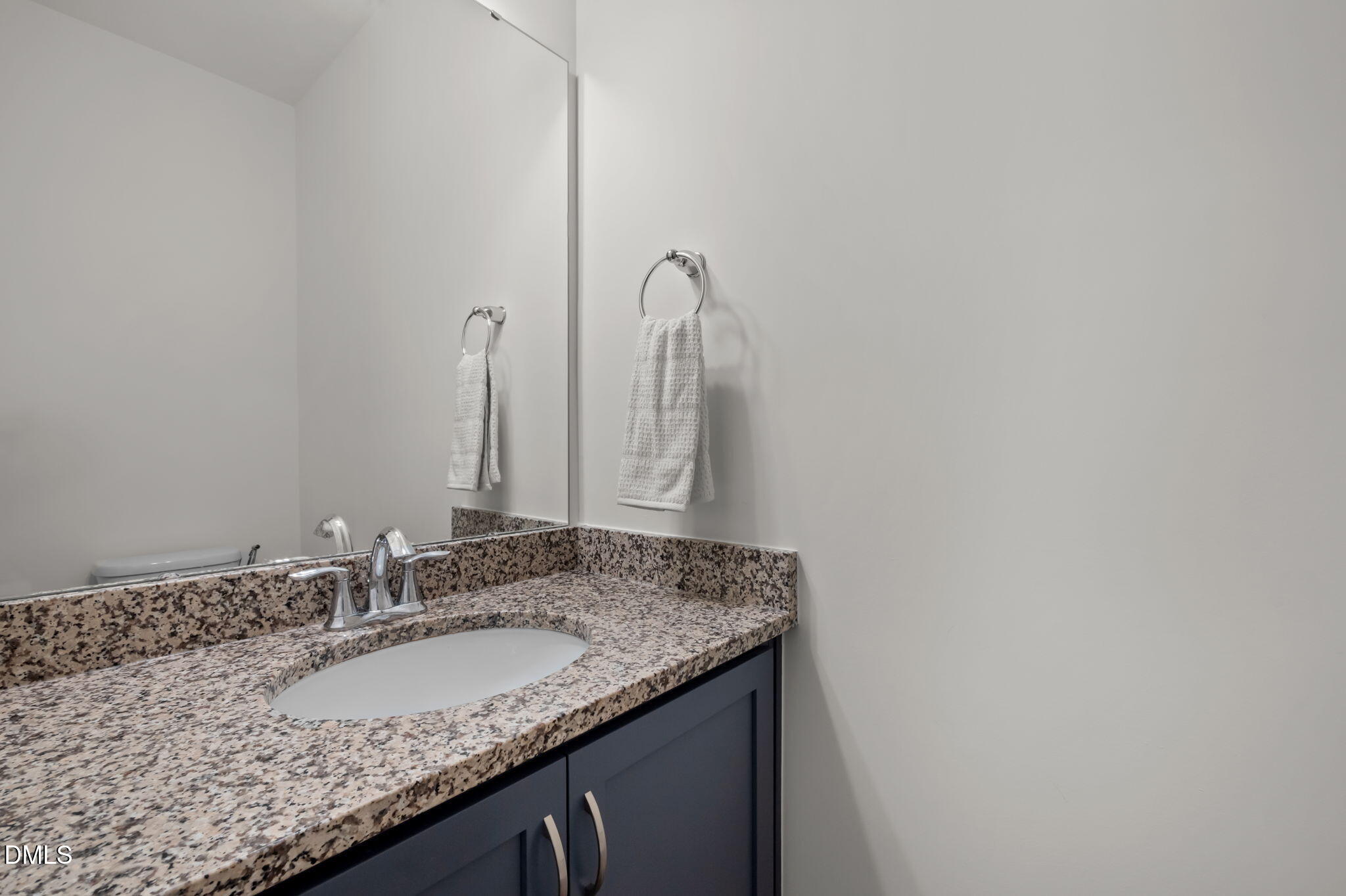 1031 Culloden Circle Durham, NC 27713 - Photo 20 of 50 a bathroom with a granite countertop sink and a mirror