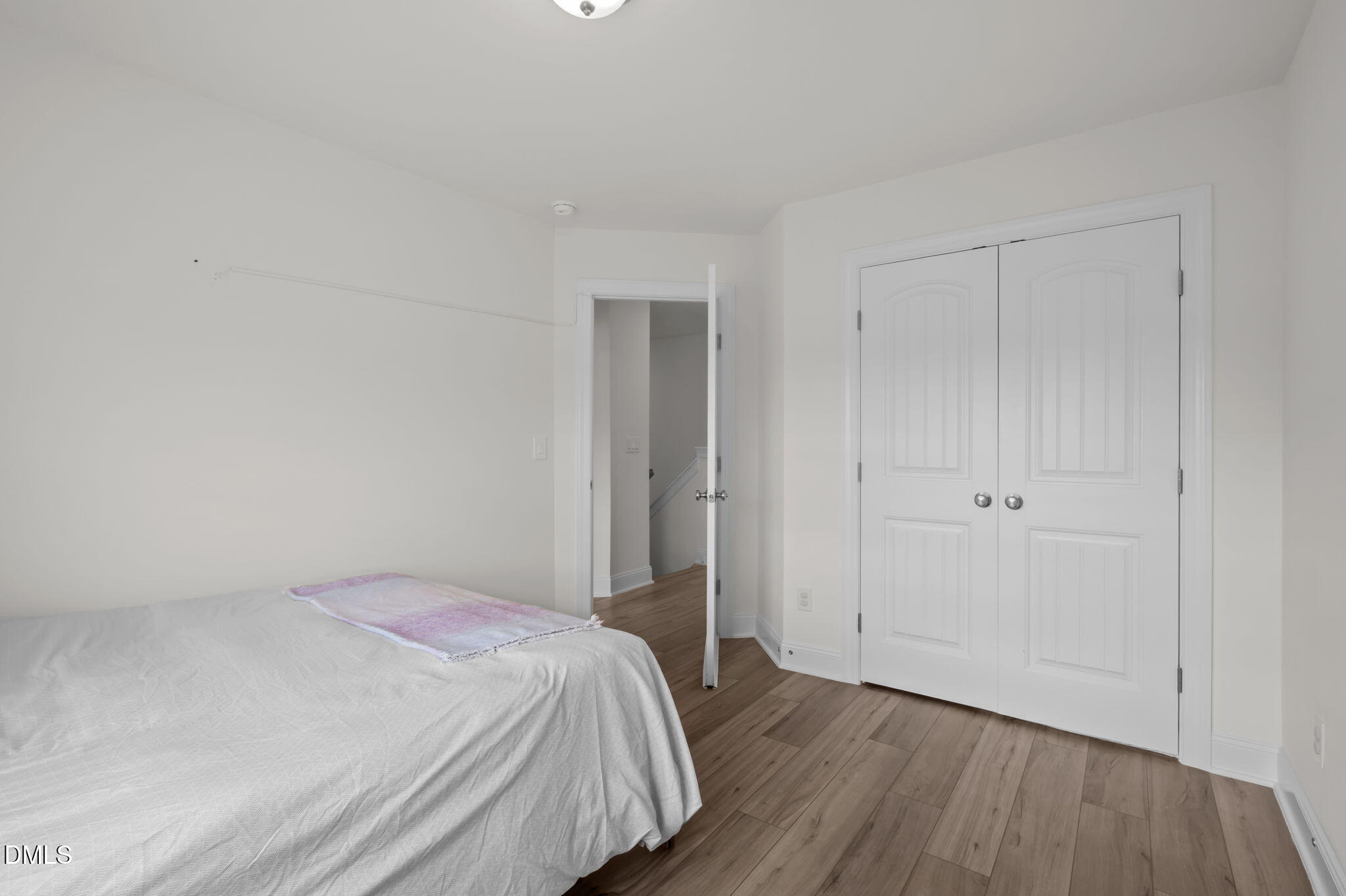 1031 Culloden Circle Durham, NC 27713 - Photo 24 of 50 a bedroom with a bed and wooden floor