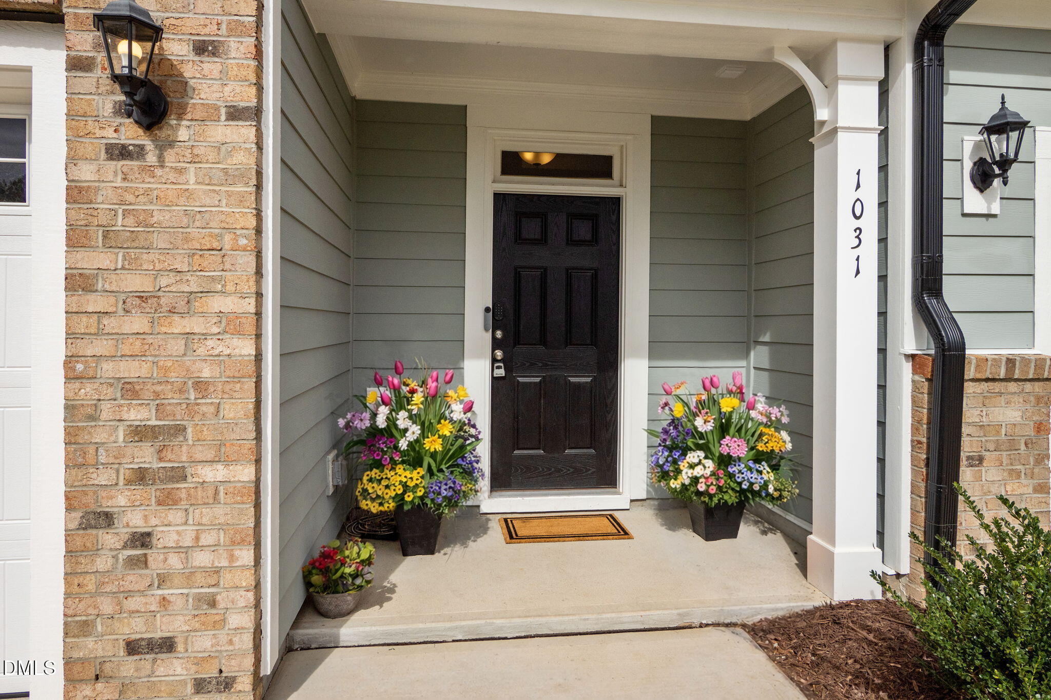 1031 Culloden Circle Durham, NC 27713 - Photo 5 of 50 a vase of flowers sitting on a floor in front of a door