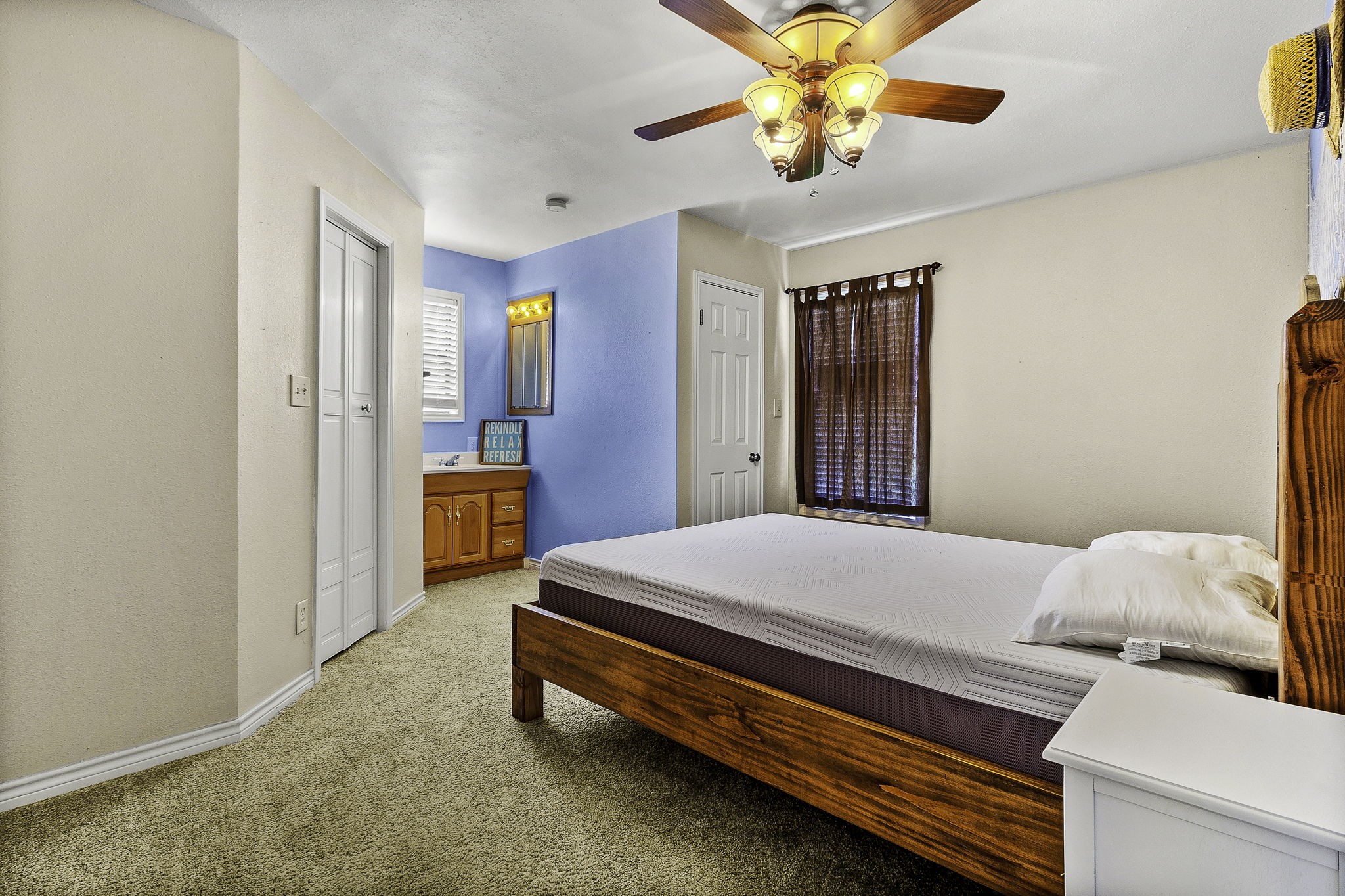 536 Weavers Cove Road Livingston, TX 77351 - Photo 22 of 44 a bedroom with a bed and a chandelier