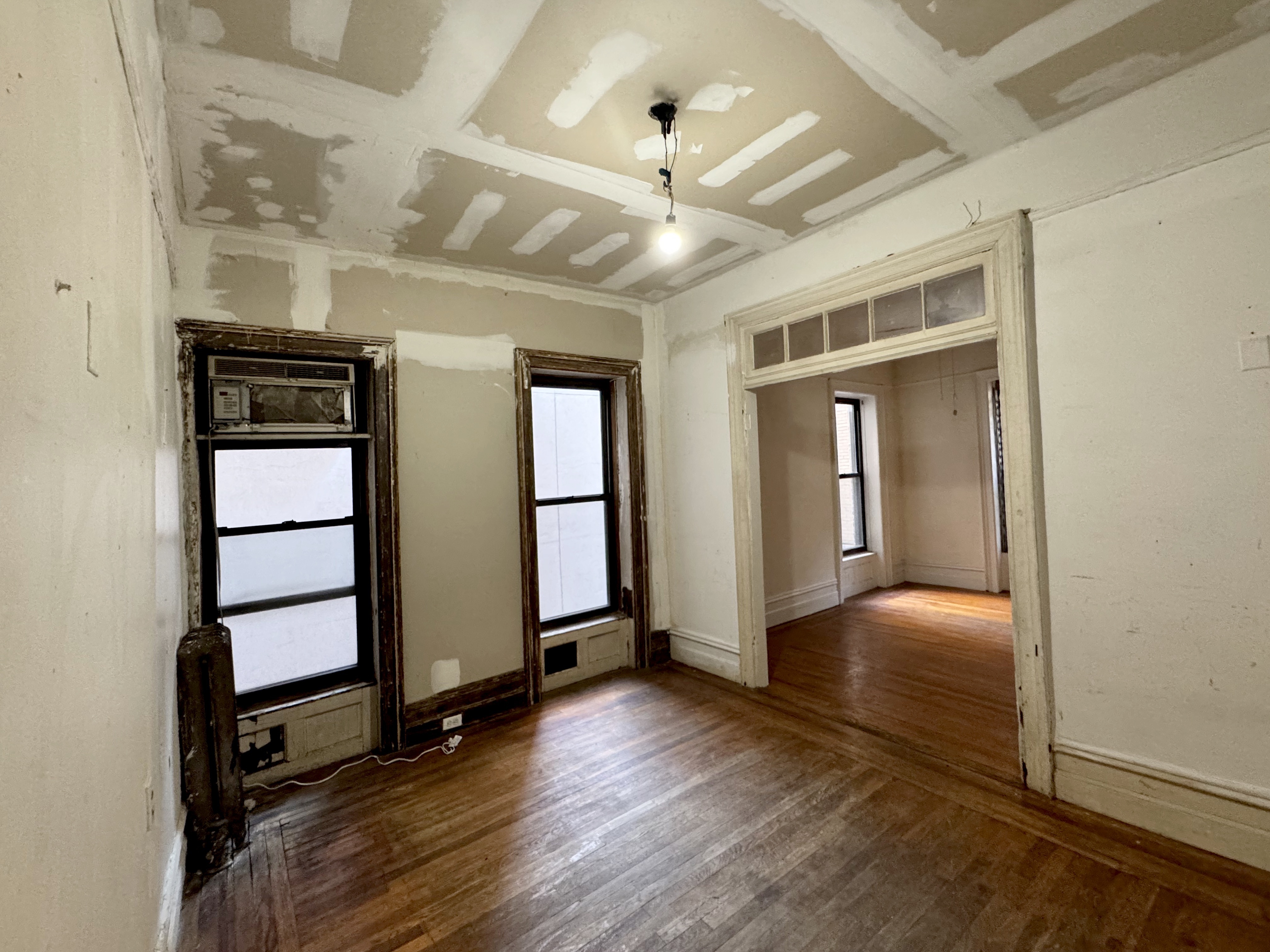 wooden floor in an empty room with a window