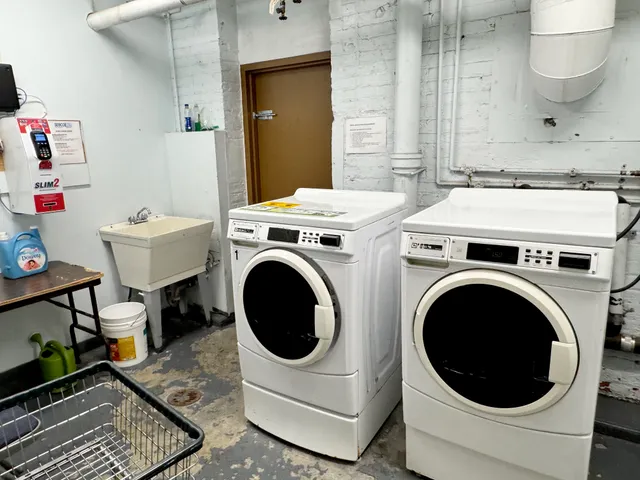a utility room with sink dryer and washer