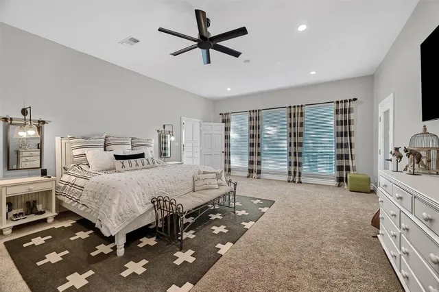 a bed room with furniture and a large window