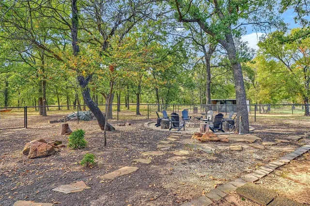 a view of a park with bench and trees