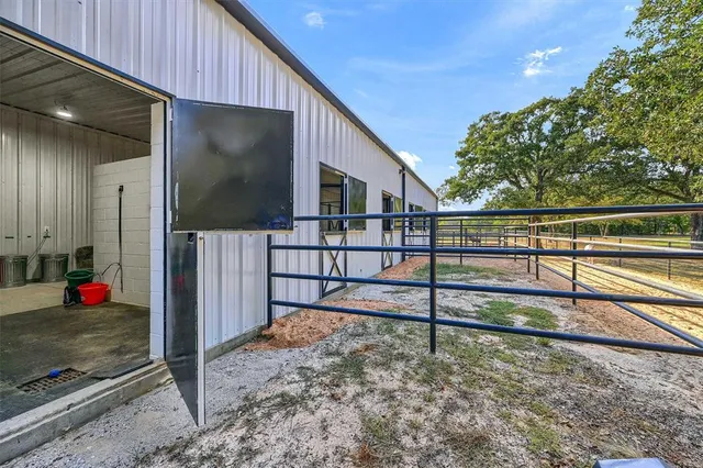 a view of a porch with wooden floor and fence