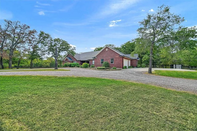 a front view of house with yard and green space