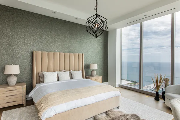 a bedroom with a bed and a chandelier