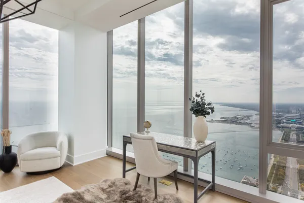 a living room with furniture and a floor to ceiling window