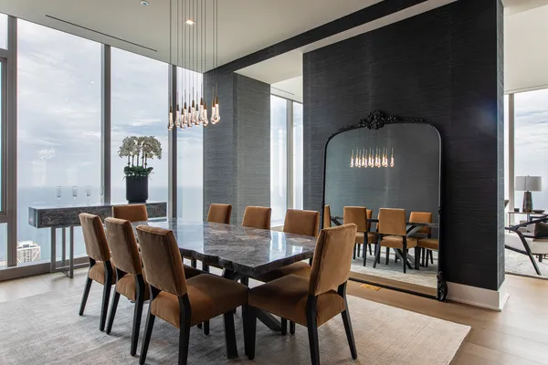 a dining room with furniture potted plants and wooden floor