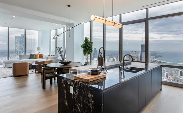 a kitchen with stainless steel appliances granite countertop a sink a stove and a wooden floors