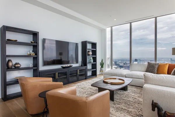 a living room with furniture a rug and a large window