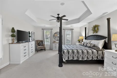 a bedroom with furniture and flat screen tv