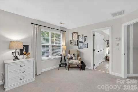 a bedroom with furniture and a window