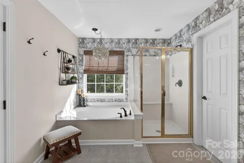 a bathroom with a bathtub and a shower