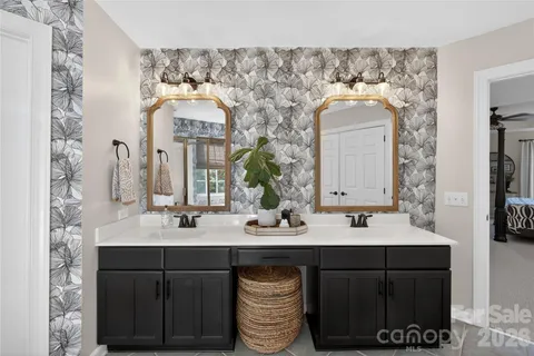a bathroom with a double vanity sink and a mirror