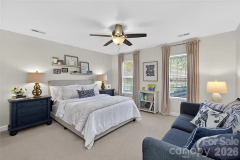 a bedroom with a bed couch and window