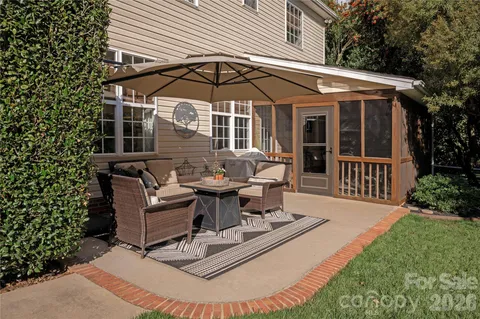 a view of a house with backyard and sitting area